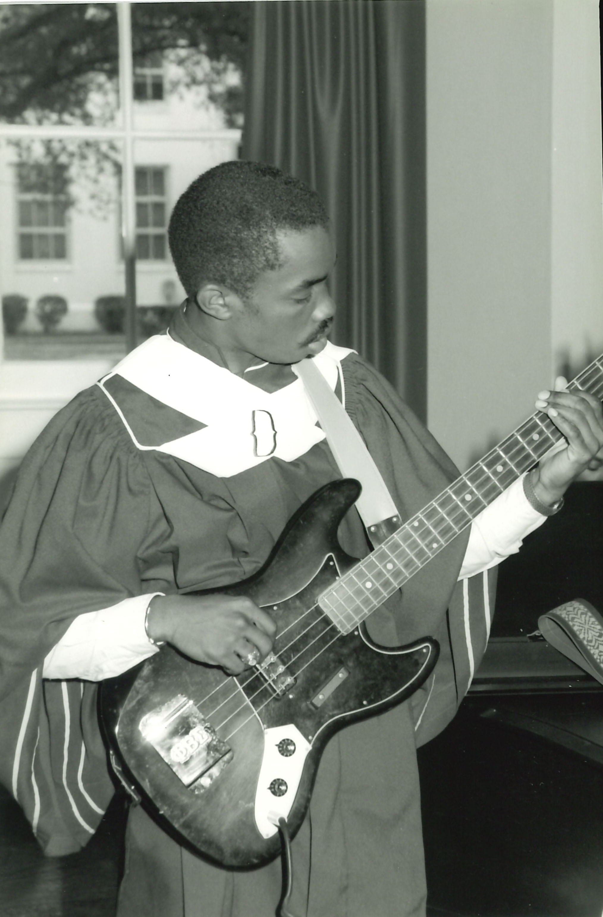 choir member playing bass guitar